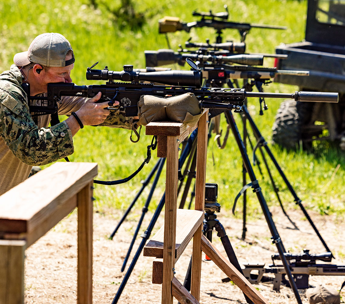 male looking through scope on rifle in basic swat training course