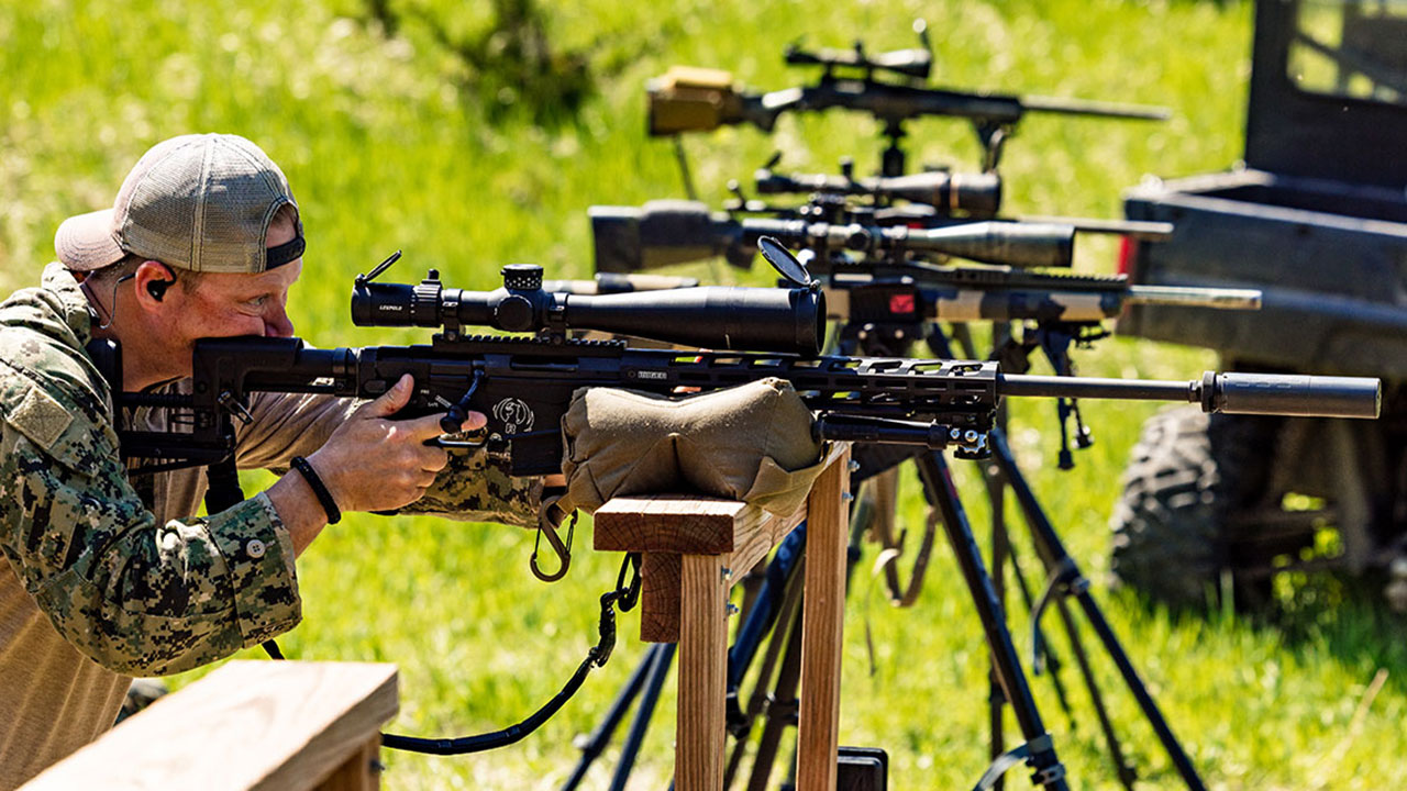 male looking through scope on rifle in basic swat training course