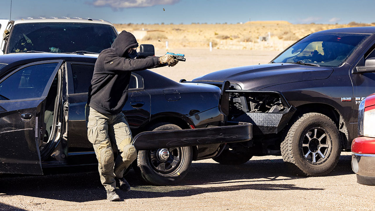 male fleeing vehicle holding firearm